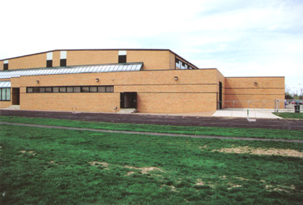 Representative photograph of a brick school exterior with large glass block window panels